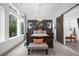 Bright bedroom with a chandelier, accent wall, and large windows showing greenery at 218 Floral Valley Dr, Woodstock, GA 30188