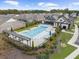 Aerial view of the sparkling community pool, cabana, and lounge area, perfect for summertime relaxation and recreation at 218 Floral Valley Dr, Woodstock, GA 30188