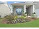 Charming front yard with vibrant flower beds, a porch swing, and stone accents at 218 Floral Valley Dr, Woodstock, GA 30188