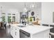 Bright, open kitchen with a large island, stainless steel appliances, and modern lighting at 218 Floral Valley Dr, Woodstock, GA 30188