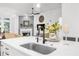 Kitchen island with a stainless steel sink and view of the fireplace and living room at 218 Floral Valley Dr, Woodstock, GA 30188
