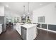Open-concept kitchen with large island and views into the living room and dining area at 218 Floral Valley Dr, Woodstock, GA 30188