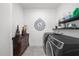 Well-equipped laundry room with modern appliances, dark wood dresser, and ample storage at 218 Floral Valley Dr, Woodstock, GA 30188