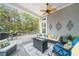 Inviting covered patio with comfortable seating, fire pit, ceiling fans, and a view of the lush backyard at 218 Floral Valley Dr, Woodstock, GA 30188