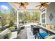 Charming covered patio with a cozy seating area, a fire pit, and views of the landscaped backyard at 218 Floral Valley Dr, Woodstock, GA 30188