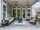 Inviting covered patio features comfortable seating, ceiling fans, and a cozy fire pit for relaxation and entertainment at 218 Floral Valley Dr, Woodstock, GA 30188