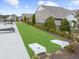 Lounge area with manicured lawn, corn hole game, and modern outdoor seating with mature landscaping at 218 Floral Valley Dr, Woodstock, GA 30188