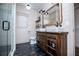 Bright bathroom with double sink vanity, rustic wood accents, and a modern glass shower enclosure at 2763 Nautical Way, Villa Rica, GA 30180