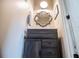 Cozy bathroom with a gray vanity, a decorative mirror and a tiled countertop at 2763 Nautical Way, Villa Rica, GA 30180