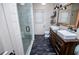 Elegant bathroom featuring a double sink vanity, wood accents, and a modern glass shower enclosure at 2763 Nautical Way, Villa Rica, GA 30180