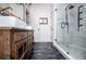 Stylish bathroom with rustic vanity, double sinks, wood-look flooring, and a sleek glass-enclosed shower at 2763 Nautical Way, Villa Rica, GA 30180