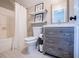Bathroom featuring modern vanity, floating shelves, and a shower-tub combo at 2763 Nautical Way, Villa Rica, GA 30180