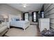 Comfortable bedroom with barn doors, a ceiling fan, and a large dresser at 2763 Nautical Way, Villa Rica, GA 30180