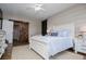 Well-lit bedroom showcasing a decorative barn door, neutral colors, and wood-look floors at 2763 Nautical Way, Villa Rica, GA 30180