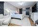 Charming bedroom with an accent wall, barn-style doors, and a cozy armchair at 2763 Nautical Way, Villa Rica, GA 30180