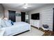 Comfortable bedroom features shiplap walls, a ceiling fan, and an inviting bed at 2763 Nautical Way, Villa Rica, GA 30180