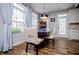 Bright dining area with a large window, stylish curtains, and wood-look floors at 2763 Nautical Way, Villa Rica, GA 30180