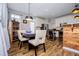 Inviting dining area featuring wood floors and a modern light fixture above a table with chairs at 2763 Nautical Way, Villa Rica, GA 30180