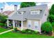 Charming home featuring a welcoming front porch, complemented by a lush green lawn and well-maintained landscaping at 2763 Nautical Way, Villa Rica, GA 30180