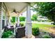 Relaxing front porch featuring cozy seating, lush greenery, and a charming view of the manicured lawn and neighborhood at 2763 Nautical Way, Villa Rica, GA 30180
