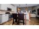 Modern kitchen features stainless steel appliances, white cabinets, and a breakfast bar with seating at 2763 Nautical Way, Villa Rica, GA 30180