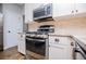 Modern kitchen features stainless steel appliances, white cabinets, and ample counter space at 2763 Nautical Way, Villa Rica, GA 30180