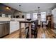 Modern kitchen features stainless steel appliances, white cabinets, and a breakfast bar with seating at 2763 Nautical Way, Villa Rica, GA 30180