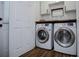 Convenient laundry room with modern washer and dryer set and white cabinets at 2763 Nautical Way, Villa Rica, GA 30180