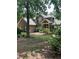 Traditional home with brick and siding exterior, showcasing a well-manicured lawn and mature trees at 50 Ranger Se Rd, Cartersville, GA 30121
