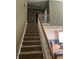 Carpeted staircase with white railings, leading to the upper level of the home at 50 Ranger Se Rd, Cartersville, GA 30121