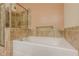 Elegant bathroom features a modern soaking tub with stylish tile surround and glass-enclosed shower at 901 Abernathy Ne Rd # 3020, Atlanta, GA 30328