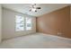 A cozy bedroom with a neutral carpet, ceiling fan, and ample natural light at 901 Abernathy Ne Rd # 3020, Atlanta, GA 30328
