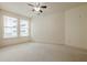 Inviting bedroom featuring neutral paint, plush carpeting, large windows, and a stylish ceiling fan at 901 Abernathy Ne Rd # 3020, Atlanta, GA 30328