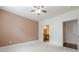 Spacious bedroom with ceiling fan; doorway leads to a bathroom with a vanity at 901 Abernathy Ne Rd # 3020, Atlanta, GA 30328