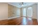 A spacious bedroom with hardwood floors, ceiling fan, and access to a balcony at 901 Abernathy Ne Rd # 3020, Atlanta, GA 30328