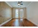 A well-lit room featuring beautiful hardwood floors, a ceiling fan, and crown moulding at 901 Abernathy Ne Rd # 3020, Atlanta, GA 30328