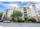 A striking exterior view of the Serrano condominium building, showcasing its architectural charm and inviting entrance at 901 Abernathy Ne Rd # 3020, Atlanta, GA 30328