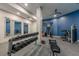 Community gym features modern exercise equipment, blue accent wall, and wall mirrors to expand the space at 901 Abernathy Ne Rd # 3020, Atlanta, GA 30328