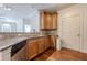 Well-equipped kitchen with granite countertops, wooden cabinets, stainless steel dishwasher, and hardwood floors offering practicality at 901 Abernathy Ne Rd # 3020, Atlanta, GA 30328