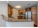 Kitchen features granite countertops, stainless steel appliances, wooden cabinets, and hardwood floors creating a warm space at 901 Abernathy Ne Rd # 3020, Atlanta, GA 30328