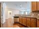 Kitchen featuring stainless steel appliances, hardwood floors, and granite countertops opening into the living room at 901 Abernathy Ne Rd # 3020, Atlanta, GA 30328