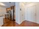 The kitchen entrance boasts stainless steel appliances, wooden cabinets, and hardwood floors; modern convenience meets classic style at 901 Abernathy Ne Rd # 3020, Atlanta, GA 30328