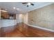 Spacious living area featuring hardwood floors, leading to a modern kitchen with stainless steel appliances at 901 Abernathy Ne Rd # 3020, Atlanta, GA 30328