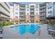 Community pool with lounge chairs and nearby apartment complex at 901 Abernathy Ne Rd # 3020, Atlanta, GA 30328