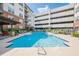 Community pool surrounded by lounge chairs and lush landscaping at 901 Abernathy Ne Rd # 3020, Atlanta, GA 30328