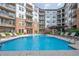 Resort-style community pool with nearby apartment buildings and plentiful lounge seating at 901 Abernathy Ne Rd # 3020, Atlanta, GA 30328