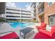 Relaxing community pool with surrounding lounge seating and apartment building in background at 901 Abernathy Ne Rd # 3020, Atlanta, GA 30328