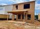 New home construction featuring an unfinished two-story exterior with a concrete patio and a yard at 116 Winsome Way, Woodstock, GA 30188