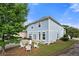 Beautiful backyard showcasing a two-story home with a cozy patio area and a well-manicured lawn at 240 Daisy Cir, Mcdonough, GA 30252