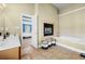 Luxurious bathroom featuring a fireplace and a soaking tub at 240 Daisy Cir, Mcdonough, GA 30252